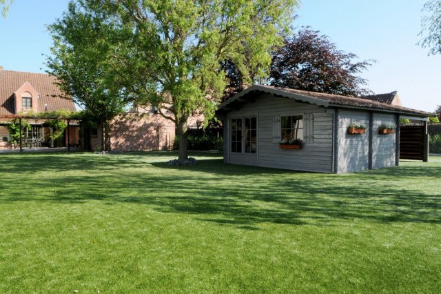 artificial grass installation around shed artificial grass installed in the back garden around a country-styled blue garden shed